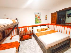a bedroom with two bunk beds in a room at HOSTAL Casa ArtVelez in Salento
