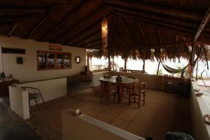a dining room with a table and chairs at Casa Vistamar y Bungalows in Los Órganos