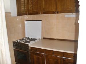 a kitchen with a stove and a counter top at Apartments by the sea Pisak, Omis - 1003 in Mimice