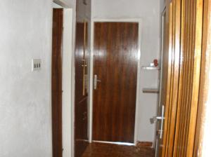 a bathroom with a shower with a wooden door at Apartments by the sea Pisak, Omis - 1003 in Mimice