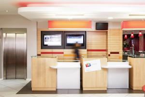 a lobby with a counter with boxes in it at Ibis Barcelona Meridiana in Barcelona