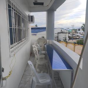 a balcony with chairs and a swimming pool at Pier La Casa Homestay Building in Surigao