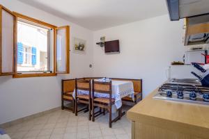 a kitchen with a table and a counter top at Apartments by the sea Nerezine, Losinj - 18734 in Nerezine