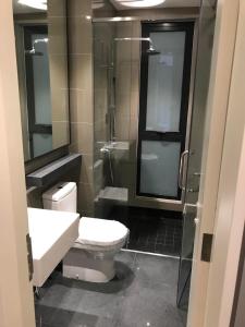 a bathroom with a toilet and a sink and a shower at LUXURIOUS AND COZY @GENTING VISTA 3B3B(FREE WI-FI) in Genting Highlands
