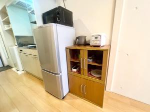 a kitchen with a refrigerator and a tv on top of it at Hamamoto Palace Taniyama - Vacation STAY 11251 in Kagoshima