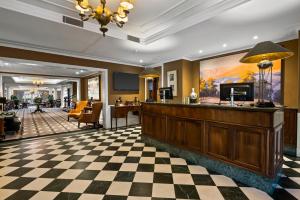 a hotel lobby with a reception desk and a checkered floor at Lilianfels Blue Mountains Resort & Spa in Katoomba