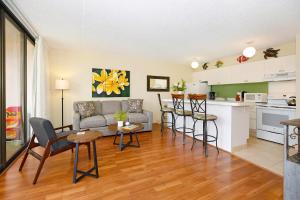 a living room with a couch and a kitchen at Waikiki Banyan #2601-T2 in Honolulu