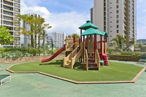 a playground with a slide in a park at Waikiki Banyan #2601-T2 in Honolulu