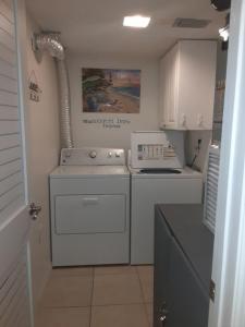 uma cozinha com um fogão branco e um lavatório em Pelican Inlet C117 condo em Saint Augustine