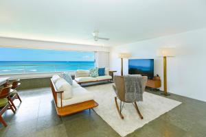 a living room with a view of the ocean at Colony Surf #604 in Honolulu