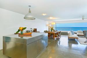 a kitchen and living room with a view of the ocean at Colony Surf #604 in Honolulu