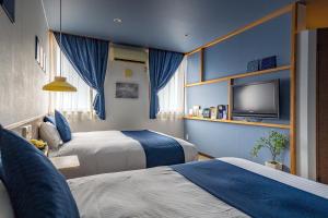 Un pat sau paturi într-o cameră la Hotel Teiregikan