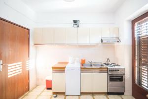 uma cozinha com um lavatório e um fogão em Apartments with a parking space Supetar, Brac - 18825 em Supetar