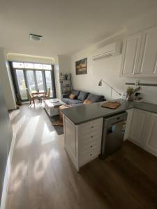 a large kitchen and living room with a couch at Banyan Place in Warrnambool