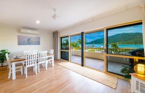 a dining room with a view of the ocean at Eagles Nest On Airlie in Airlie Beach