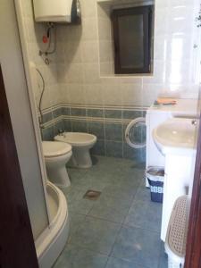 a bathroom with two toilets and a sink at Holiday house with a parking space Olib - 18805 in Olib
