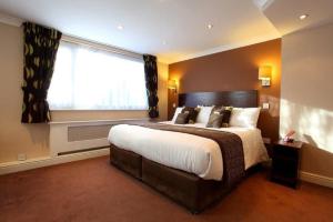 a bedroom with a large bed and a window at Dolphin SA1 in Swansea
