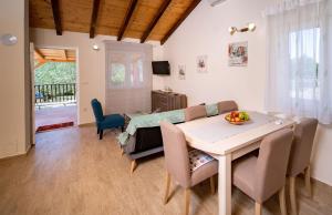 a dining room with a table and chairs at Holiday house with a parking space Mundanije, Rab - 18889 in Rab