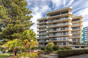 a tall building with trees in front of it at Pinnacle 202 in Forster