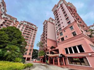 two tall pink buildings in a city at MARINA COURT PENTHOUSE VACATION HOME 5 BEDROOMS KOTA KINABALU - 15 pax in Kota Kinabalu