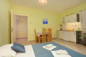 una camera da letto con un letto e una cucina con un tavolo di Apartments with parking space Omis - 18919 a Omiš (Almissa)