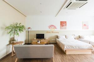 a white bedroom with a bed and a tv at SETAPAK CENTRAL KL-zeta suite by ALOHA in Kuala Lumpur