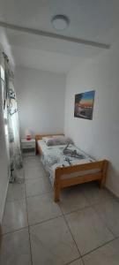 um quarto com uma cama e uma fotografia na parede em Apartments by the sea Gradac, Makarska - 18877 em Gradac