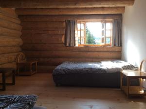 a bedroom with two beds and a window at Nadgora SkyHouse in Žabljak