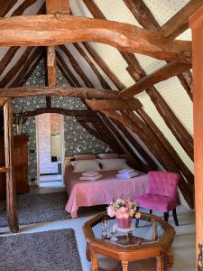 a bedroom with a bed and a table in a attic at roquebrune in Saint-Alvère