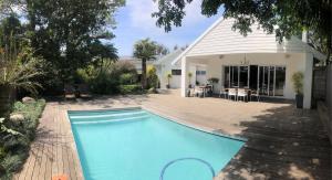 a swimming pool in front of a house at Bunkers Inn Guesthouse in East London