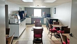 a restaurant with a counter and tables and chairs at Super Inn & Suites Philadelphia in Philadelphia