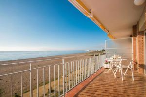 a balcony with a view of the beach at Maresme Beach Apartment in Canet de Mar