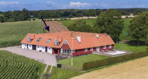 a house with an orange roof in a field at Ingridgården in Båstad
