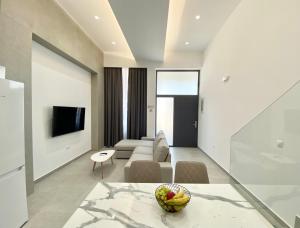 a living room with a couch and a table at Hotel Alex in Methoni