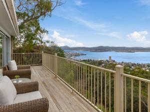 a balcony with chairs and a view of the water at Spectacular Views - 5 Bedroom House and Unit - Free Parking - Free WIFI in Sandy Bay