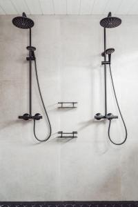 three shower systems on a wall in a room at Fort Aurora in Levi