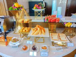 a buffet of food on a table with plates of food at Alan Sea Hotel Danang in Da Nang