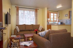 a living room with a couch and a table at The Cycads Suites in Nairobi