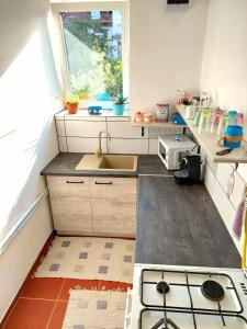 a small kitchen with a sink and a stove at La Casita Vendégház in Eger