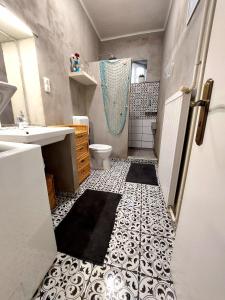 a bathroom with a shower and a toilet and a sink at La Casita Vendégház in Eger