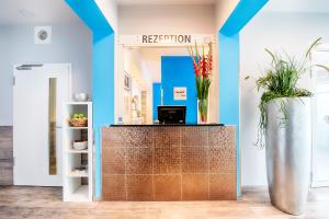 a reception area with a vase of flowers on a counter at Select Hotel City Bremen in Bremen