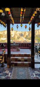 a room with a table and a view of mountains at Olivia Cave Hotel in Goreme