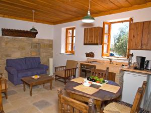 a kitchen and a living room with a table and chairs at Eveleos Country House in Tochni