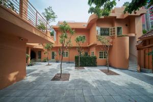 a courtyard of a house with trees in front of it at M Village The Tropic in Ho Chi Minh City