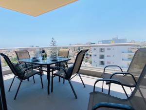 a table and chairs on a balcony with a view at Silver Line 1-Bedroom Apartment in Larnaca in Larnaca