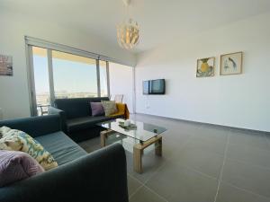 a living room with a couch and a table at Silver Line 1-Bedroom Apartment in Larnaca in Larnaca