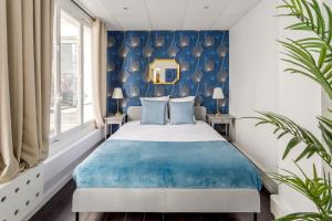 - une chambre avec un lit et un mur bleu dans l'établissement Cosy 5 bedrooms with patio - Louvre Museum, à Paris