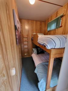 a small room with two bunk beds in it at Queenstown Copper Country Cabins in Queenstown