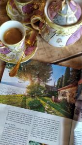 a magazine with a cup of coffee on a table at piccola casa naturale sul lago in Varenna