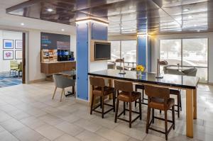 a lobby with a bar and chairs in a store at Holiday Inn Express New Orleans Downtown, an IHG Hotel in New Orleans